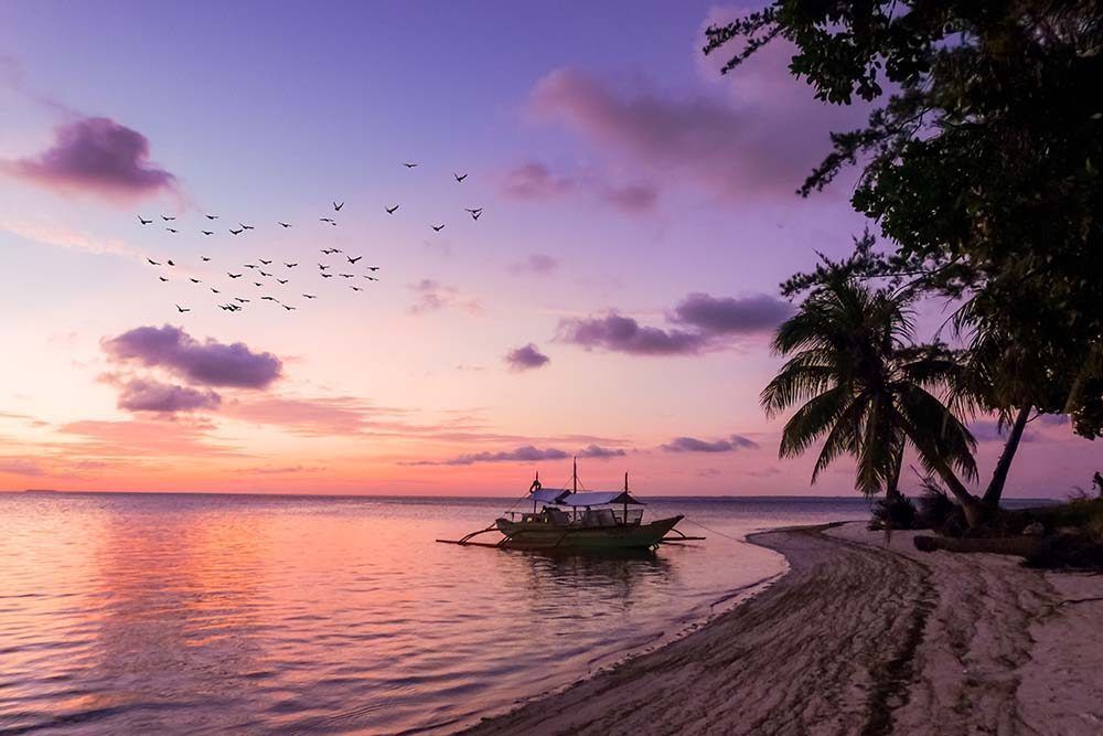 Tropical Island Sunset - Photo by Cris Tagupa on Unsplash