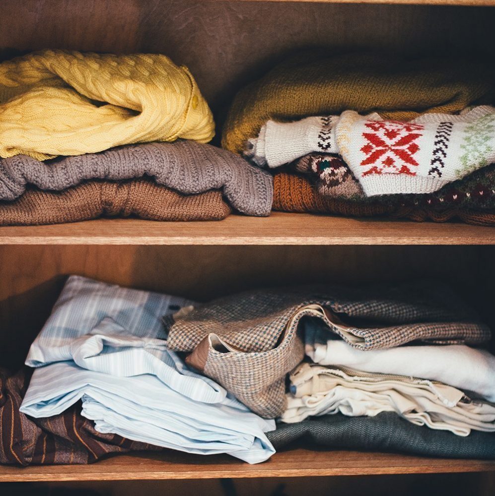 Mix of folded jumpers on two shelves