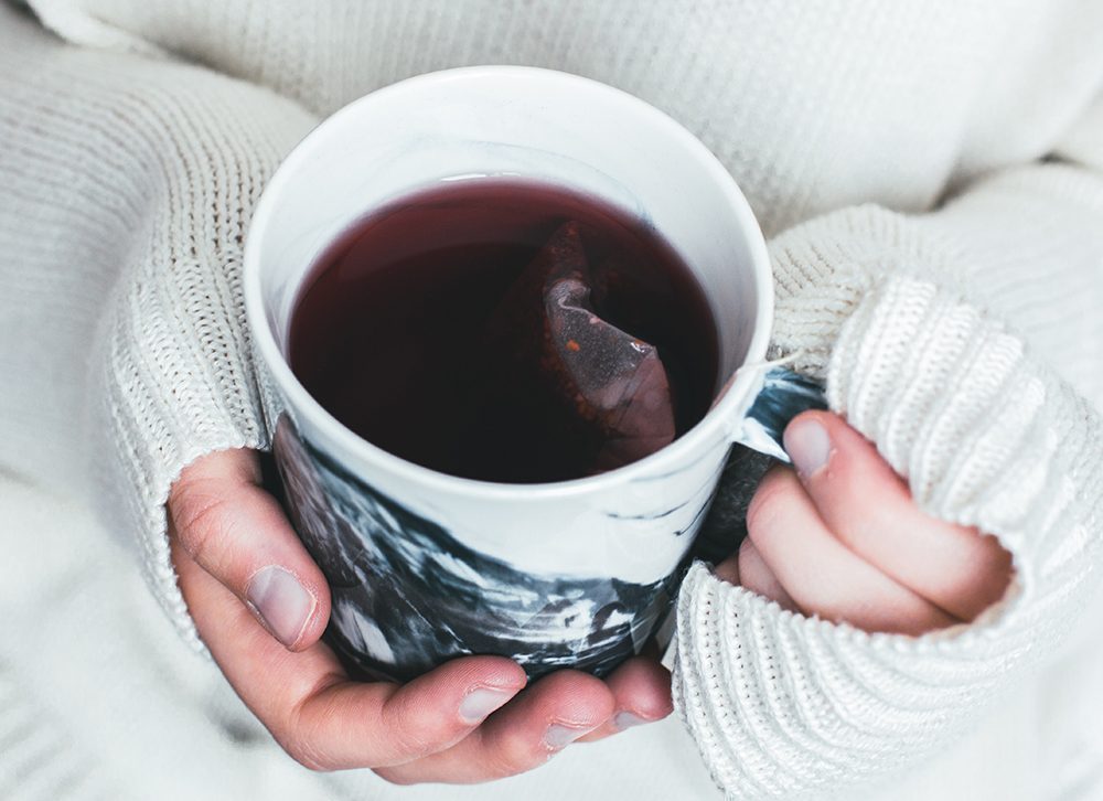 Looking down into a mug of hot tea with teabag in