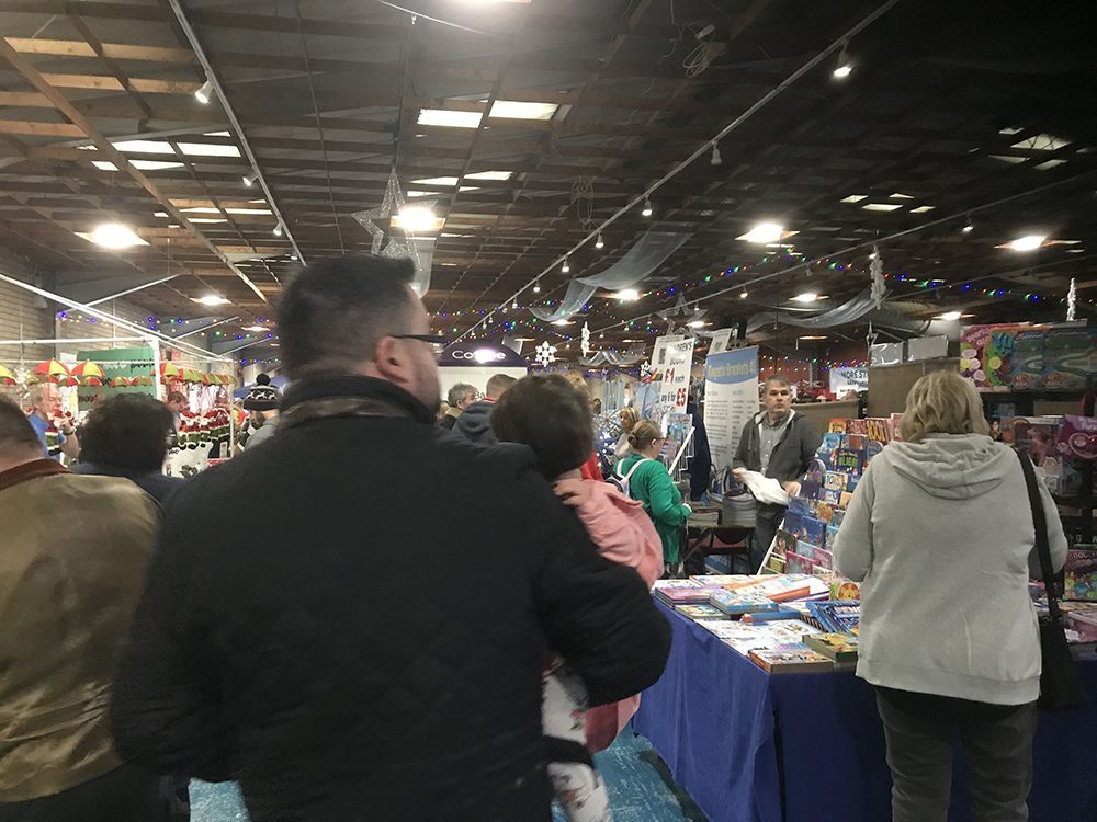 Handmade food stalls at a food fair surrounded by crowds of people