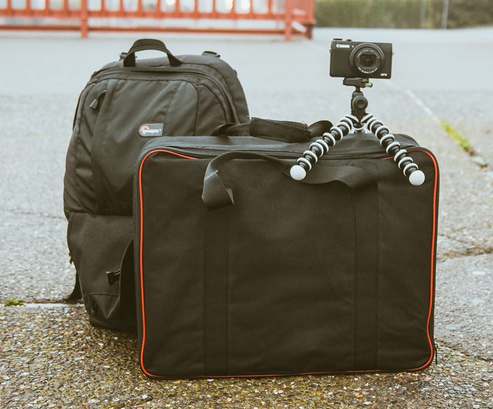 Packed bags and a camera on a tripod