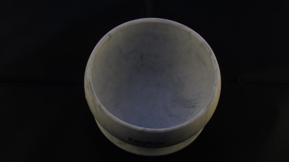 Grey marble effect bowl against black background