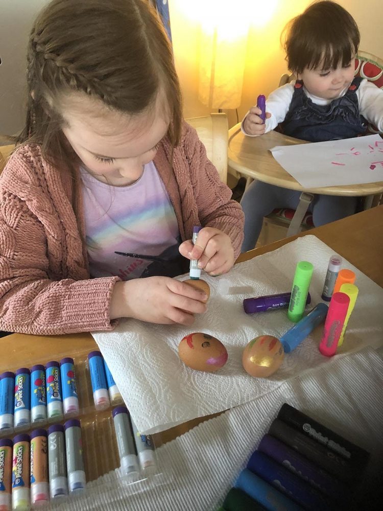 Painting Hard Boiled Eggs with green paint sticks