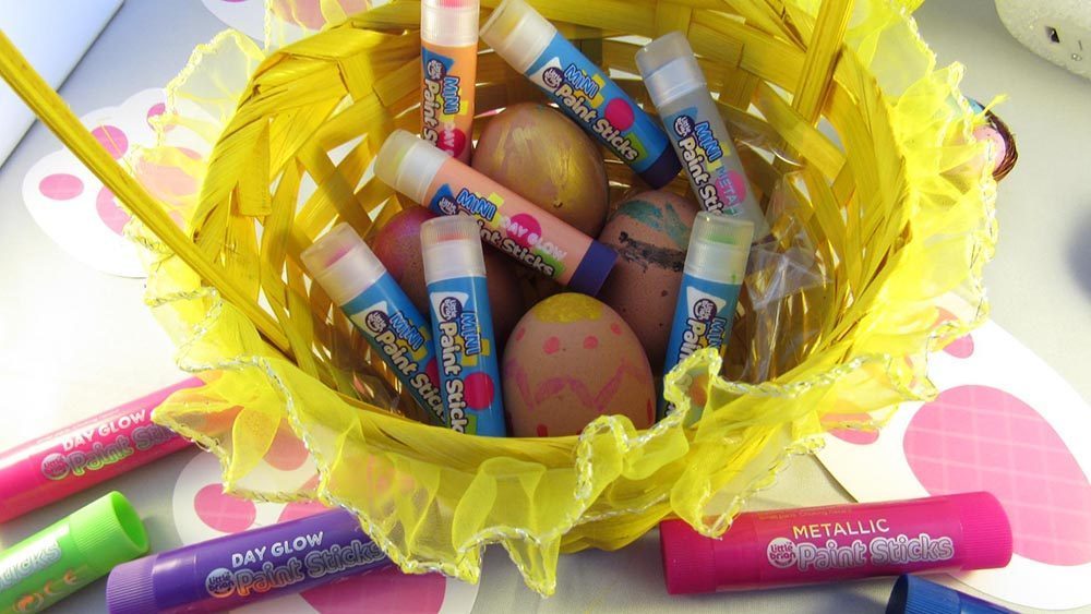 Yellow basket full of paint sticks and eggs