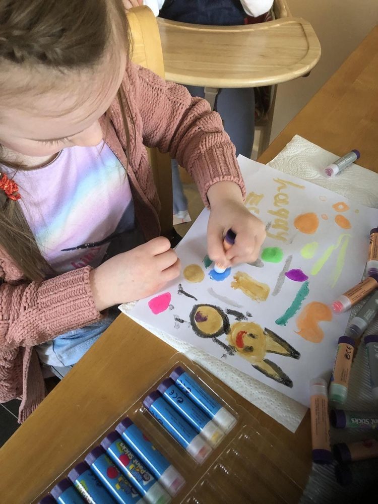 Mia painting a rabbit on paper