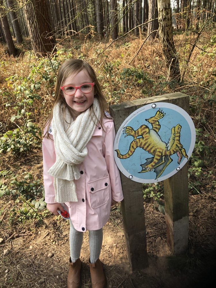 Mia with a dragon trail sign