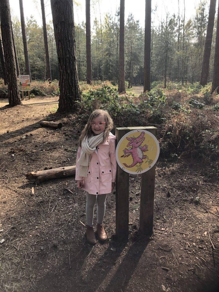 Mia stood with a dragon trail sign