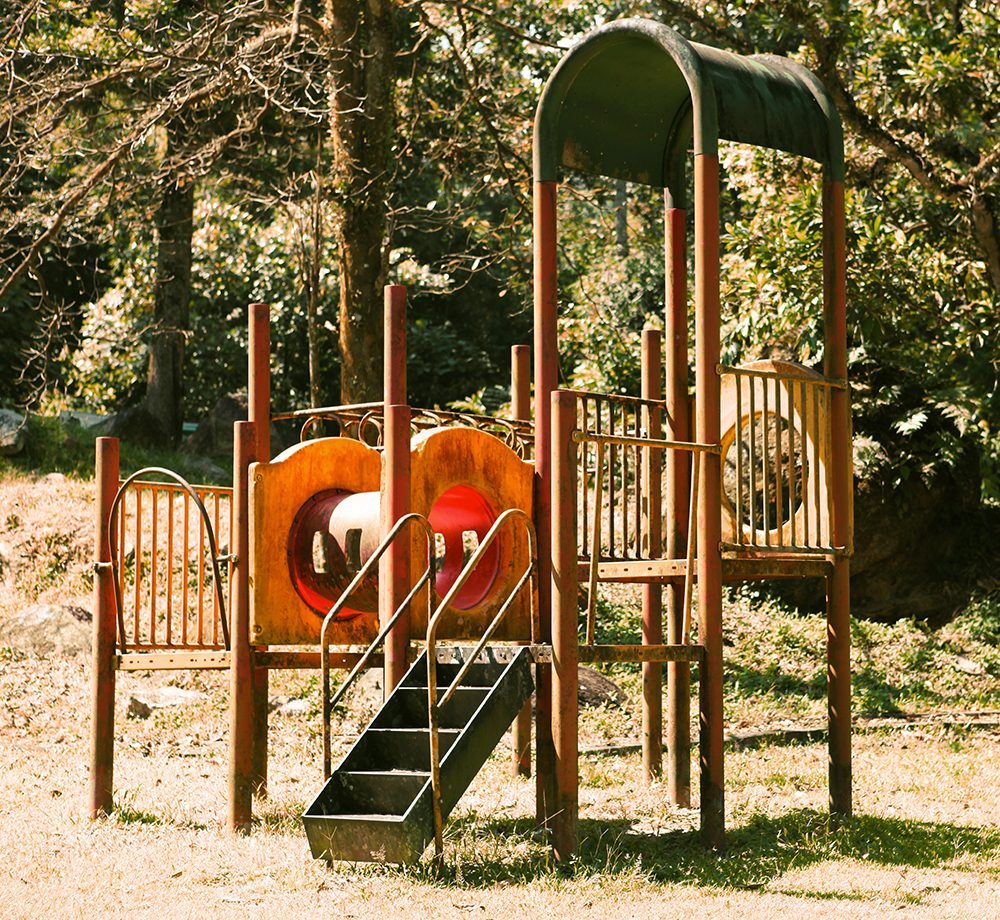 Playground play frame in a grassier area